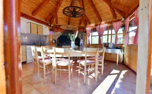 a kitchen and dining room with a table and chairs at House Marinic in Grabovac