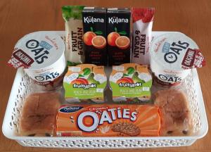 a lunch box with various food items on a table at Pendine Sands Bed & Breakfast in Pendine