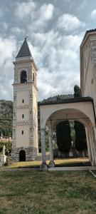 a building with a tower with a clock on it at Casa SAN FELICE in Mori
