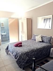 a bedroom with a bed and a couch at Ambiente Budget Accommodation in Upington