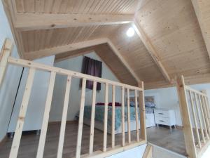 a loft bedroom with a bed and a staircase at Guest House Koba in Batumi