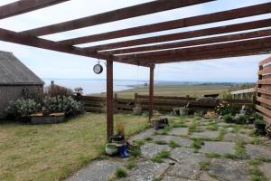 a pergola with a view of the ocean at Fabulous location with sea and castle view - NC500 in Keiss