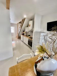 a kitchen and dining room with a wooden table at Casinha da Patricia in Nazaré