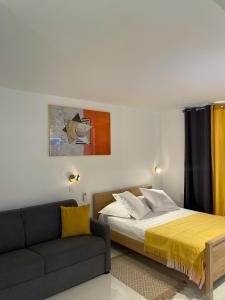 a bedroom with a bed and a couch at Diamond Paradise in Le Diamant +18 photos