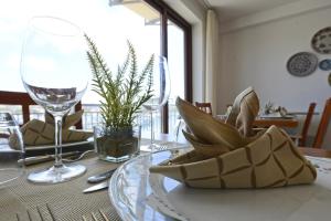 a dining room table with a plate and wine glass at Best Western Hotel Martello in Lampedusa