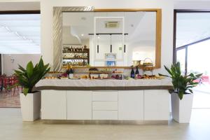 a kitchen with a counter with food on it at Hotel Martello in Lampedusa