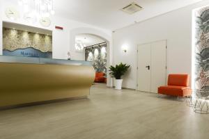 a lobby with an orange chair and a waiting room at Best Western Hotel Martello in Lampedusa