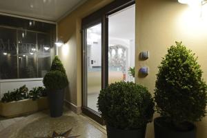 a lobby with potted plants in front of a window at Best Western Hotel Martello in Lampedusa