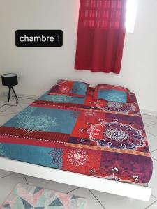 a bed with a quilt on top of a table at A la montagne in Morne Vert