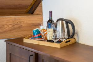 a wooden tray with wine bottles and glasses on a counter at Apartments-Rooms Stara Varos in Žabljak