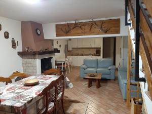 a living room with a table and a blue couch at La casa di Walter e Rosa in Castel di Sangro