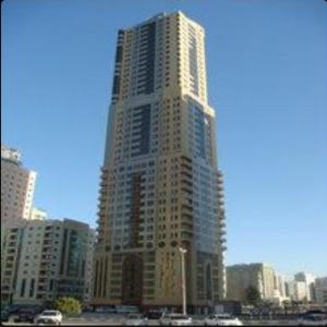 a tall building in the middle of a city at شقق ليماس القصباء in Sharjah