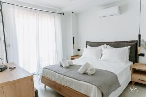 a bedroom with a large bed with towels on it at Elaionas Estate Perdika in Perdika +27 photos