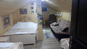 a small room with a bed and a couch at Holiday Home Racha in Ambrolauri