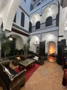 a living room with couches and tables in a building at Riad Assalam in Marrakech