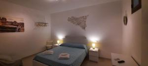 A bed or beds in a room at Casa Andolina White