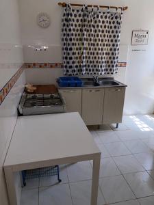 a kitchen with a sink and a stove in it at Swiss Garden House in Kerr Sering With Full Private Compound in Amdalai +6 photos