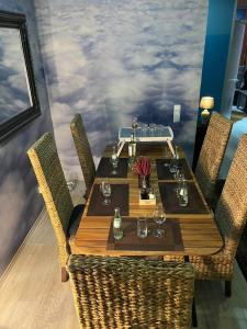 a dining table with chairs and a mural of clouds at Luxury Gemütliche WOHNUNG in Eigelstein Köln in Cologne +17 photos