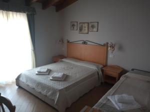 Кровать или кровати в номере Rosa dei Venti