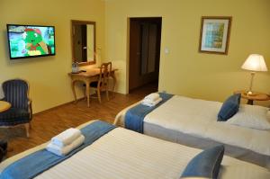 Łóżko lub łóżka w pokoju w obiekcie Hotel Mir-Jan SPA