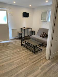 a living room with a couch and a coffee table at Appartement 2 personnes proche plage(900m) dans une maison individuel. in Hendaye