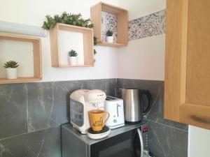 a kitchen with a coffee maker on a counter at Le cocoon Hyper centre Orleans proche Gare in Orléans