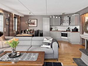 a living room with a couch and a kitchen at 11 person holiday home in Noresund-By Traum in Noresund