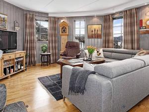 a living room with a couch and a tv at 11 person holiday home in Noresund-By Traum in Noresund