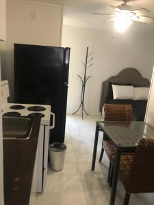 a kitchen with a stove and a table and a couch at Sage Hills Motel in Cache Creek