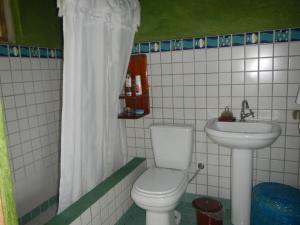 a bathroom with a toilet and a sink at Casa Ilhabela in Ilhabela