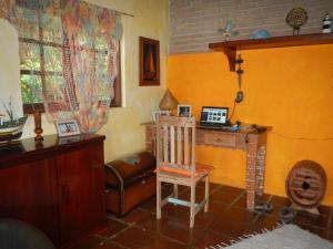 a living room with a desk and a chair at Casa Ilhabela in Ilhabela