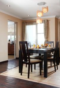 a dining room with a black table and chairs at Retreat Serviced Apartment in Kathmandu