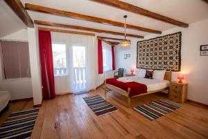 a bedroom with a bed and a large window at Casa Bradut in Dorna Arini
