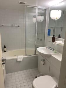a bathroom with a shower and a toilet and a sink at Winterbrook Chalet in Mount Buller