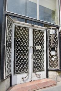 a front door of a building with a gate at Standard Apartment by Hi5 - Center of city center in Budapest