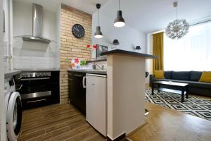 a kitchen with a counter and a living room at Standard Apartment by Hi5 - Center of city center in Budapest