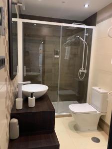 a bathroom with a shower and a toilet and a sink at APARTAMENTO LAS NIÑAS in Ronda +17 photos