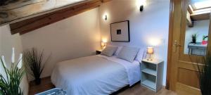 a bedroom with a white bed in a room at LA CASA DE FUENTETOBA in Fuentetoba +88 photos