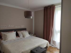 a bedroom with a white bed with a window at Alba Opatija in Opatija