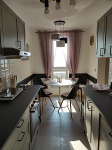 a kitchen with a table and chairs in a room at Alba Opatija in Opatija