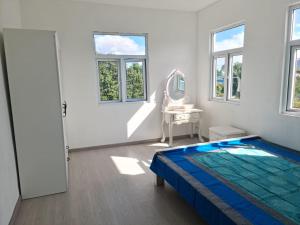 a white bedroom with a bed and a mirror at Lovely brand new luxury 2-bedroom apartment in Vacoas, Mauritius in Réunion