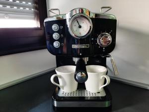 a coffee maker with two cups on a counter at Maximus 2 in Čakovec