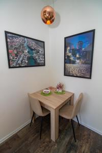 a dining room with a wooden table and chairs at Apartman Sarah Mostar in Mostar +19 photos