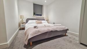 une chambre avec un lit avec une couverture et une fenêtre dans l'établissement Modern & Central, Perfect Beach Getaway- 2min Walk, à Brighton et Hove