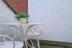 une table et des chaises avec une plante en pot dans l'établissement Modern & Central, Perfect Beach Getaway- 2min Walk, à Brighton et Hove 1 autre photo