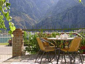 a table and chairs with a view of a mountain at Apartment Mimosa in Kotor