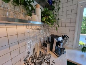 a kitchen counter with wine glasses on a wall at Nyrenoverad stor villa 15 mintuer från Göteborg centrum in Västra Frölunda