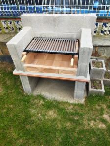 a bench sitting in the grass next to a fence at A Pedriña Ribadeo in Ribadeo