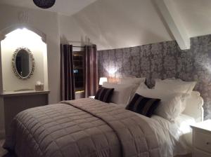 a bedroom with a large bed and a window at Bourton Croft Cottage in Bourton on the Water