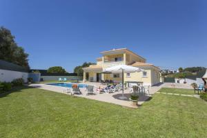 a house with a swimming pool in the yard at Villa Solange by Villa Plus in Albufeira